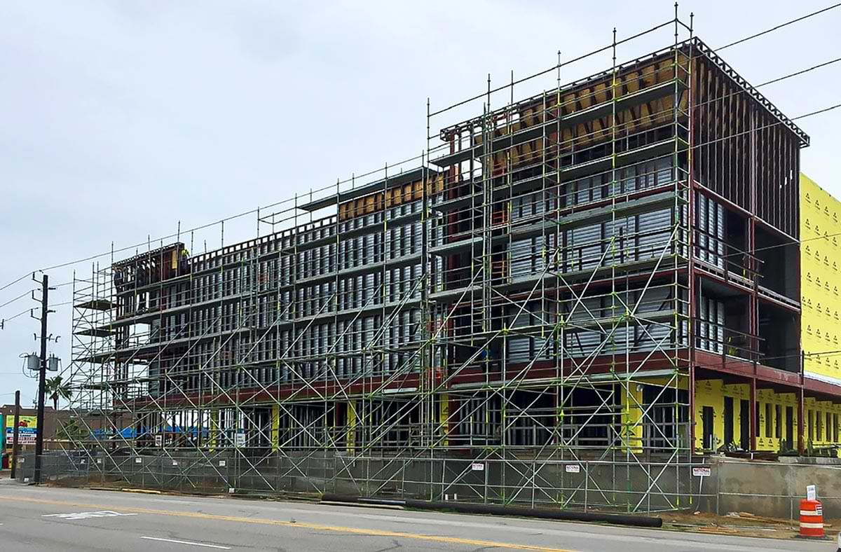 view from the adjacent street of the Home Team Storage facility structures frame during construction