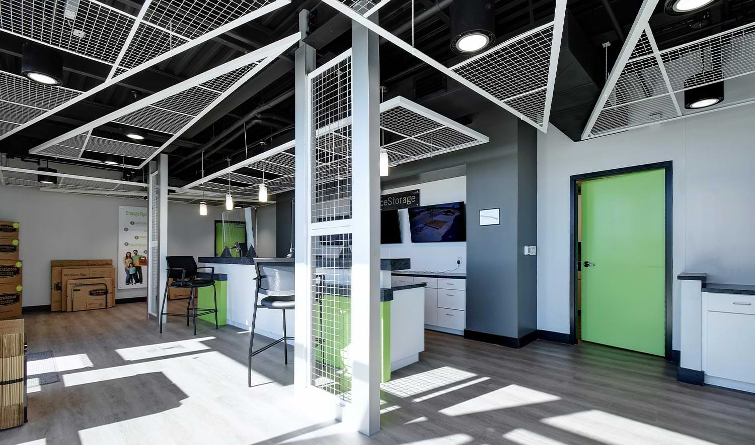 view of a large modern styled office with neon green accented doors and counters