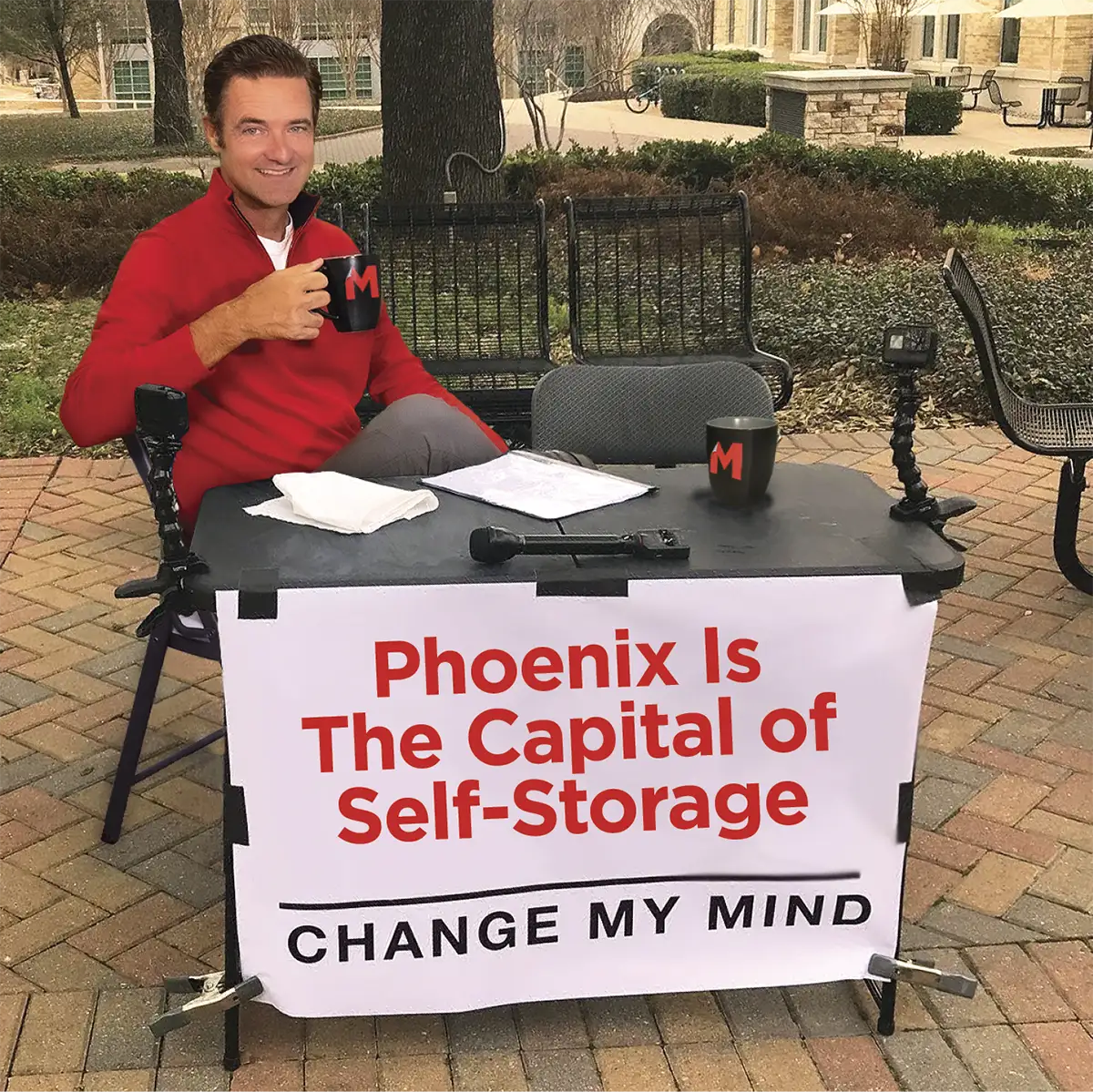 Travis Morrow as a popular meme with Phoenix is the Capital of Self Storage Change My Mind written on a banner