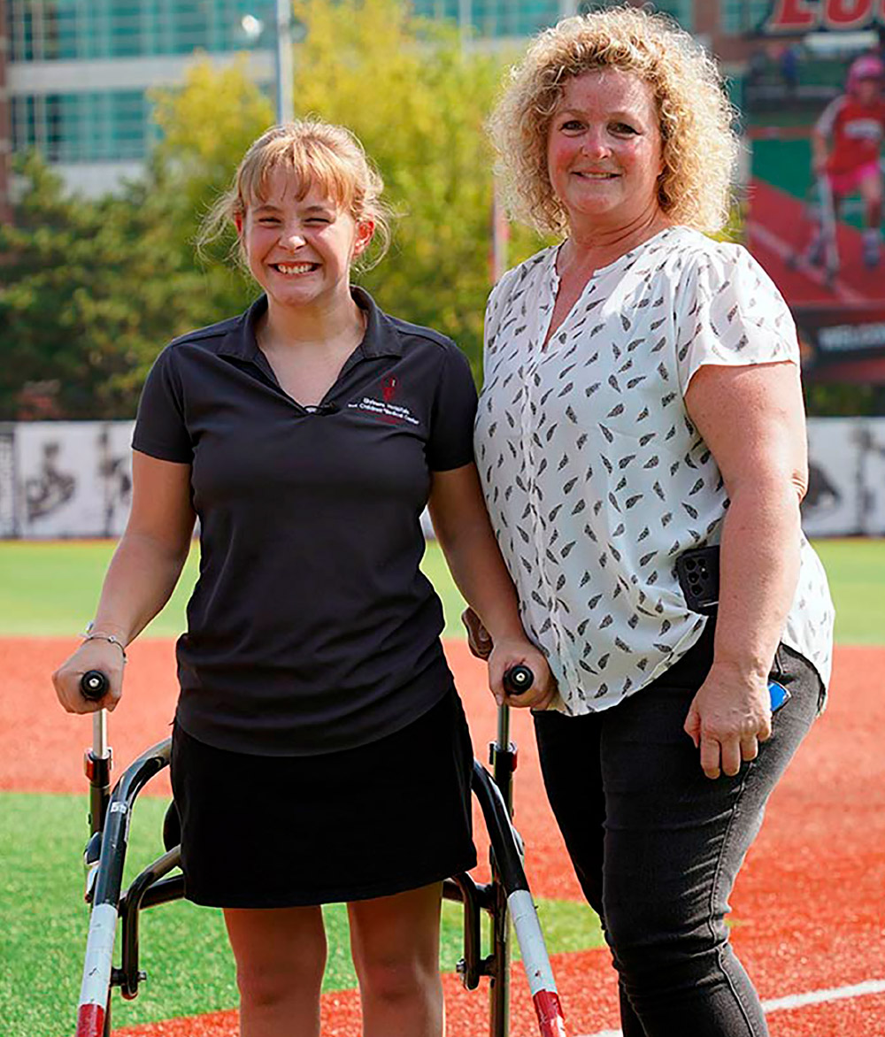 mother and daughter smiling at race event on track