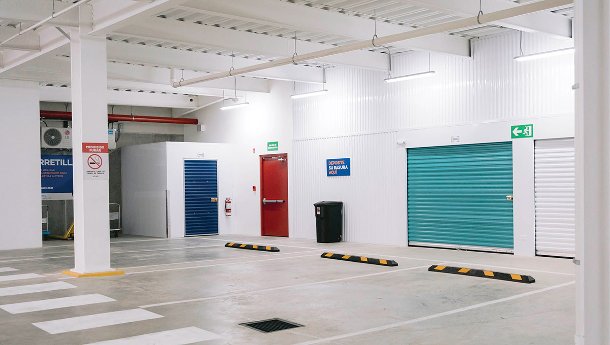 well lit storage units with parking spaces in front