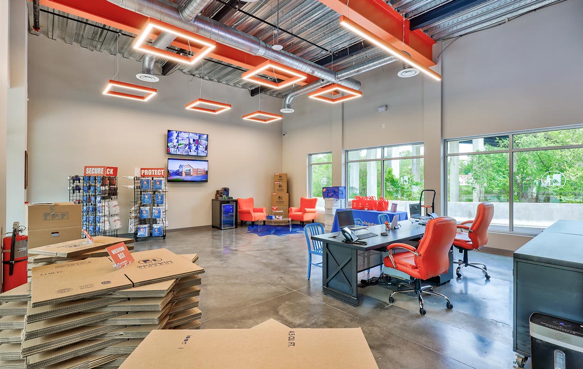 corner view of the spacious Morningstar Storage lobby furnished with a deep blue and vibrant orange color scheme