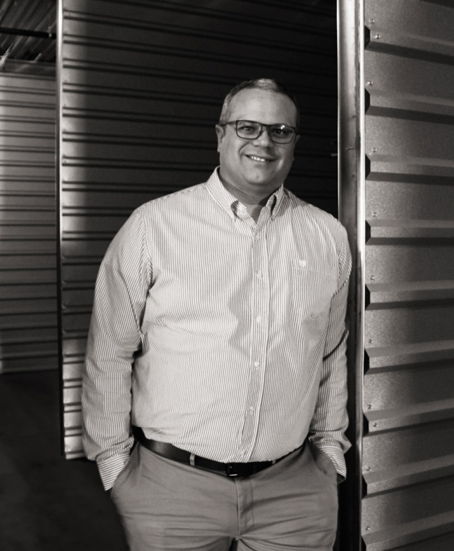 Devan Williams leaning against metal door with hands in pockets