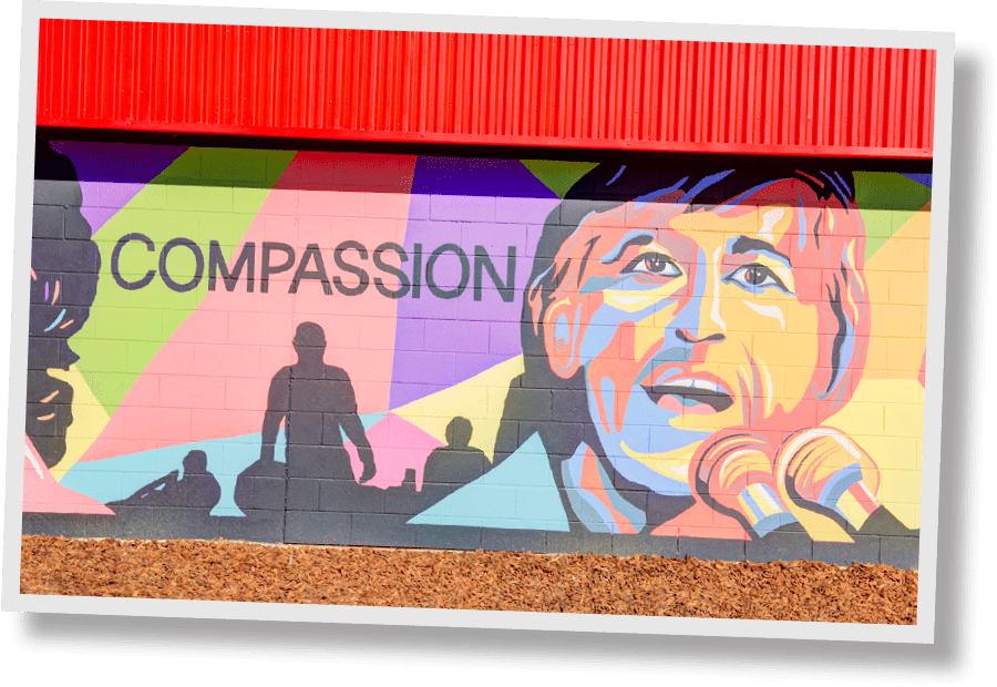 security public storage mural with historic figure Cesar Chaves and the word compassion