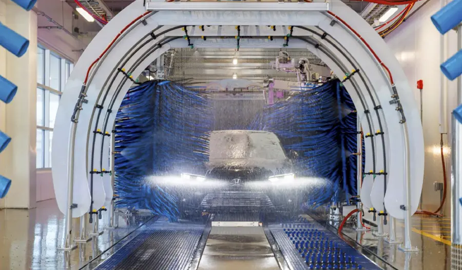 view down the lane of the Great White car wash as it services a sedan