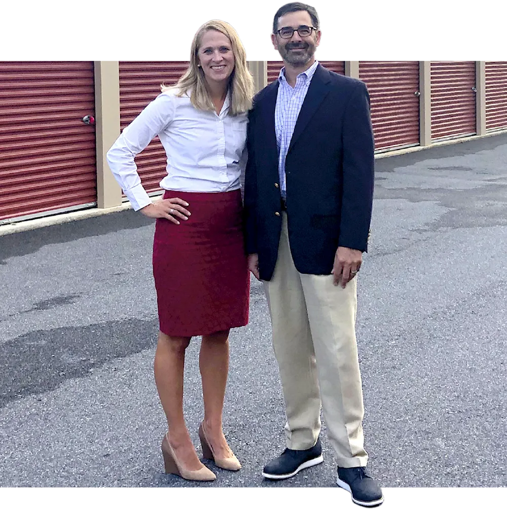 Alyssa Quill standing with her husband at an outdoor storage facility 