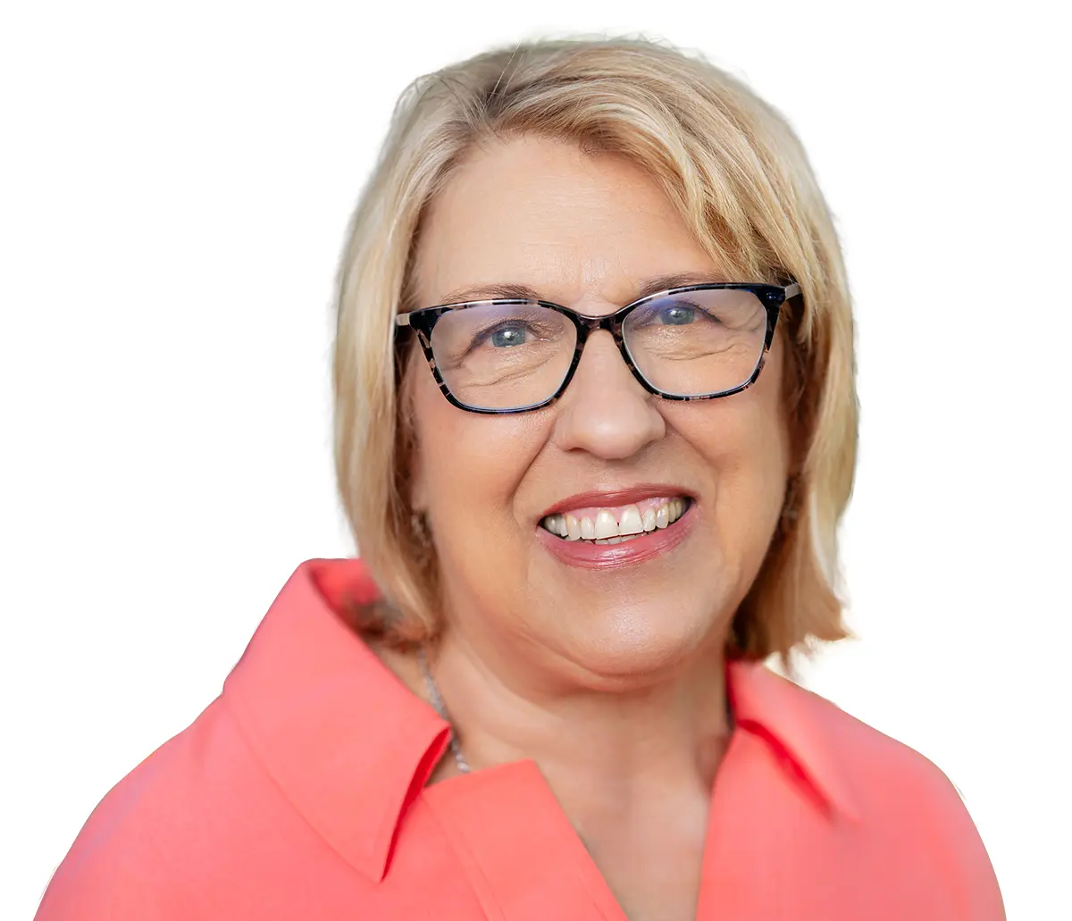 Portrait headshot photograph of Ann Parham smiling in a light hot pink colored blouse top and black outer frame/chrome-tinted inner frame prescription see through glasses