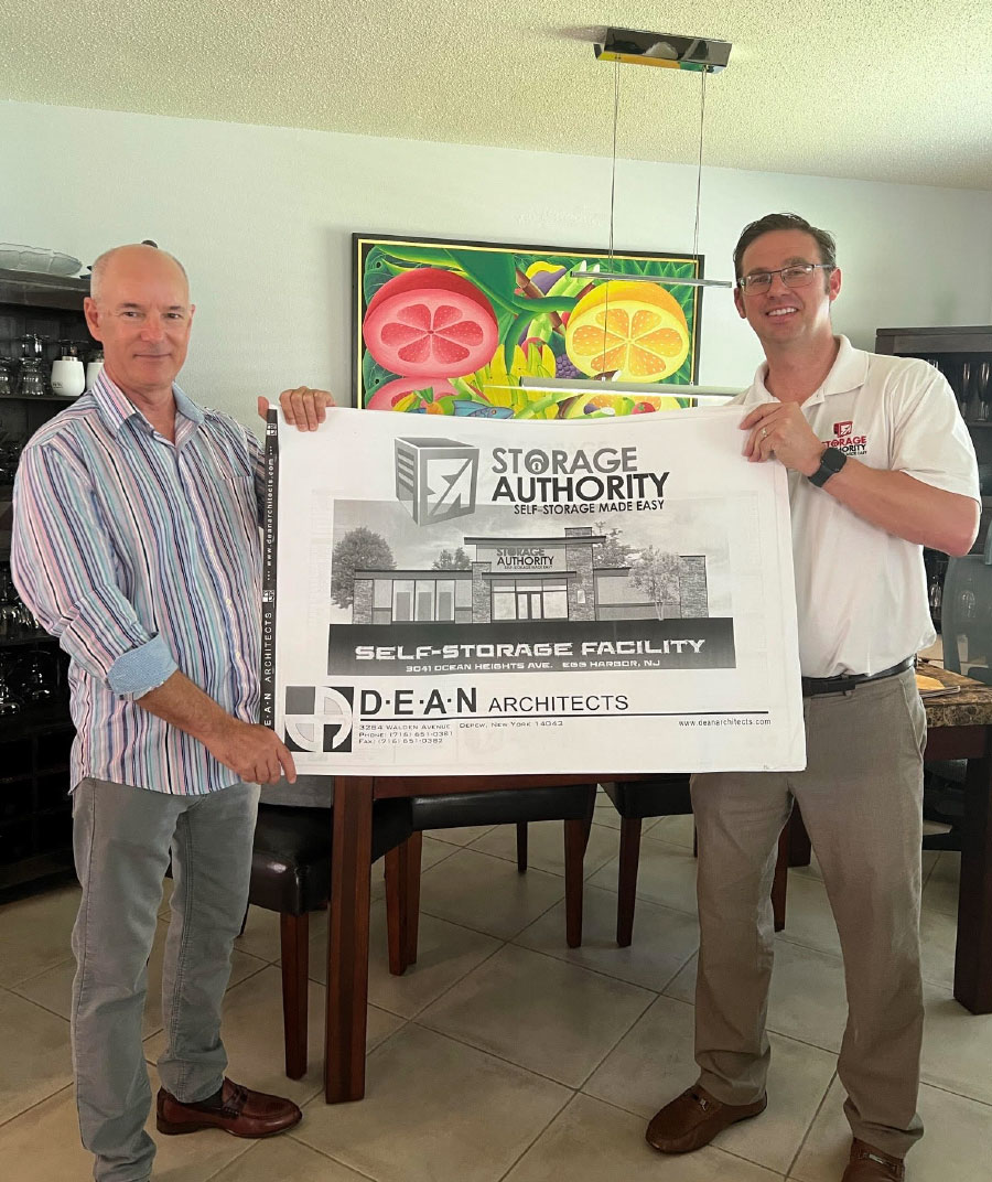 two men holding Storage Authority banner