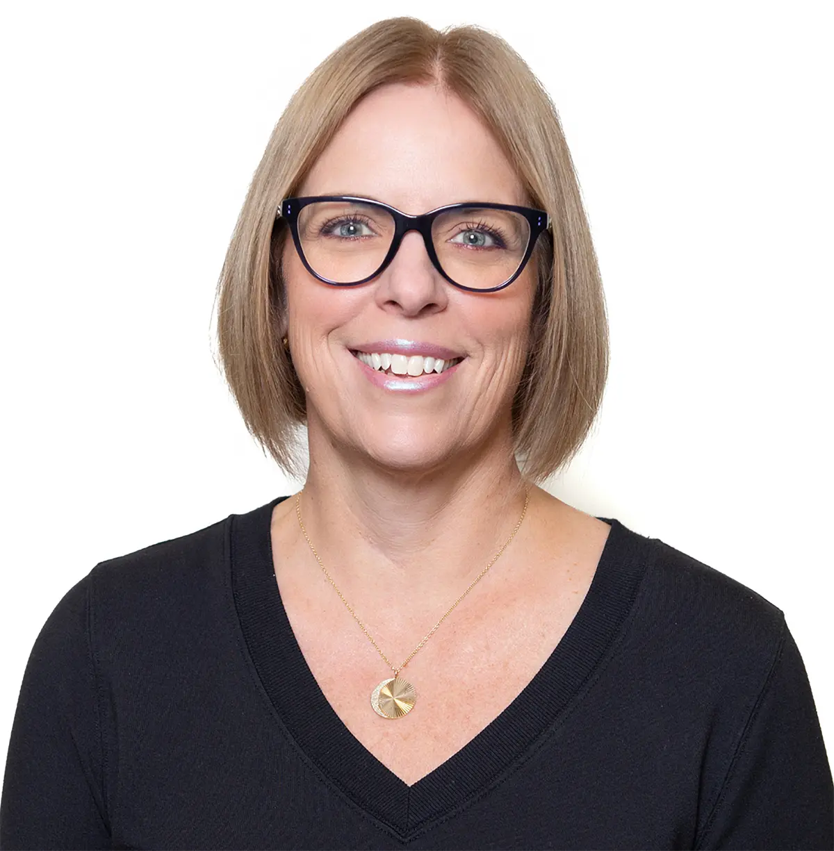 Portrait headshot photograph of Maureen A. Lee smiling in a black v-neck blouse top, black outer frame/chrome-tinted inner frame prescription see through glasses, and a circular gold-colored necklace