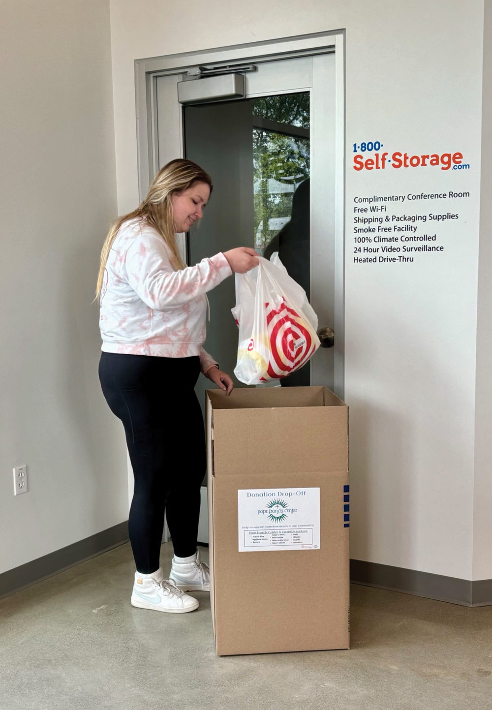 woman pulling a bag out of a box at a storage facility