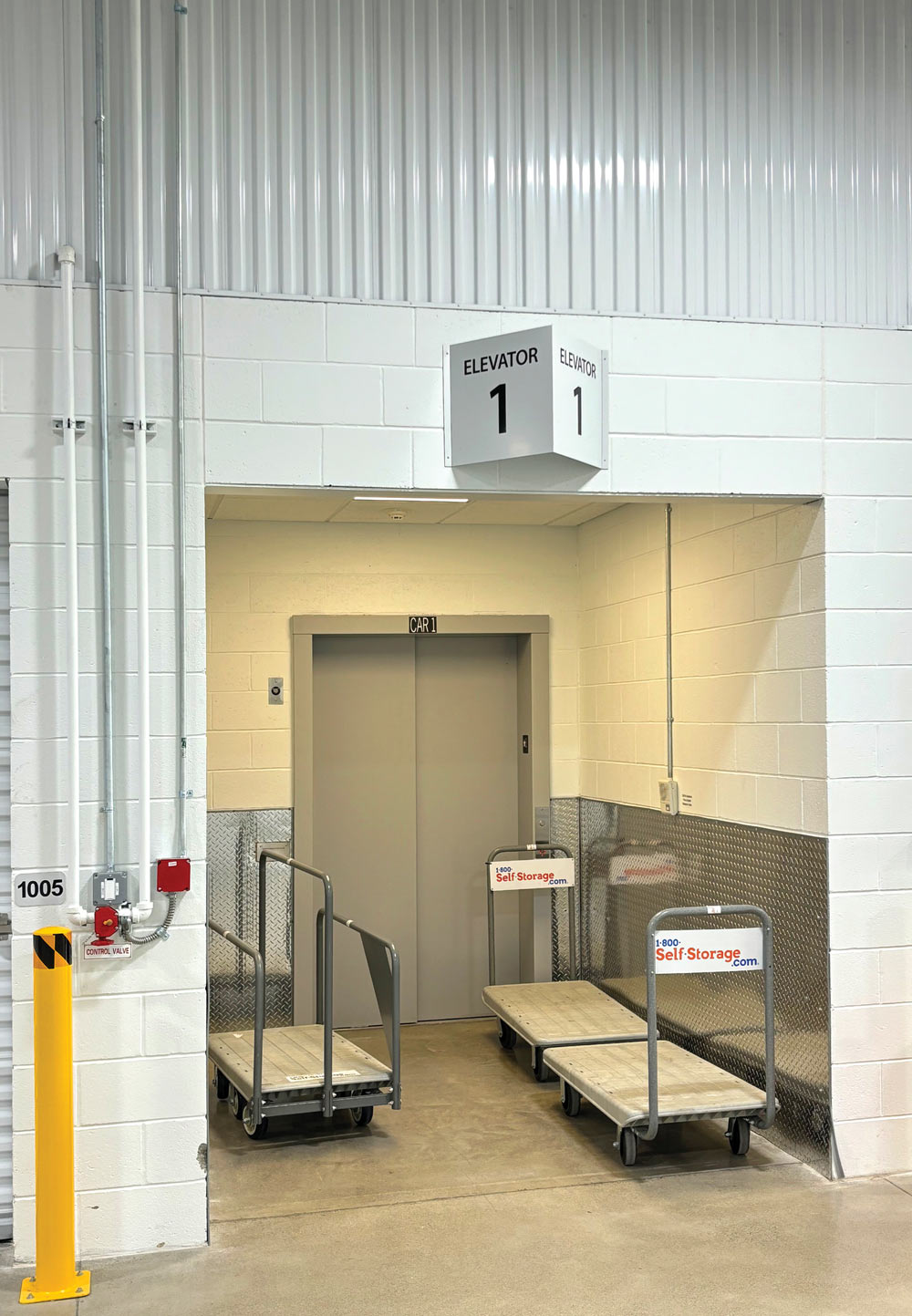 push carts next to an elevator inside a storage facility