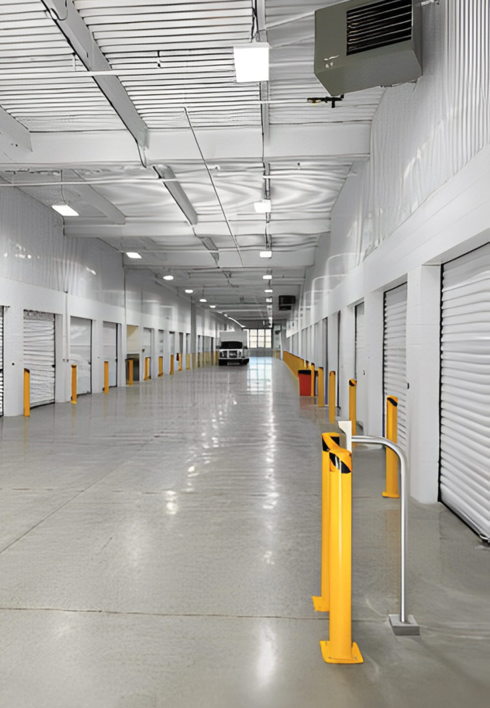 storage unit doors down a hallway inside a storage facility