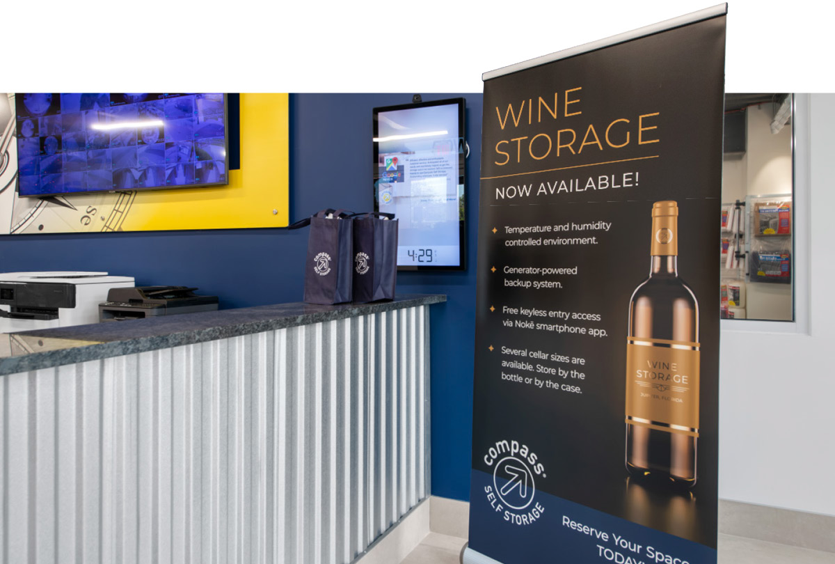 a wine storage poster on display in the Compass Self Storage lobby