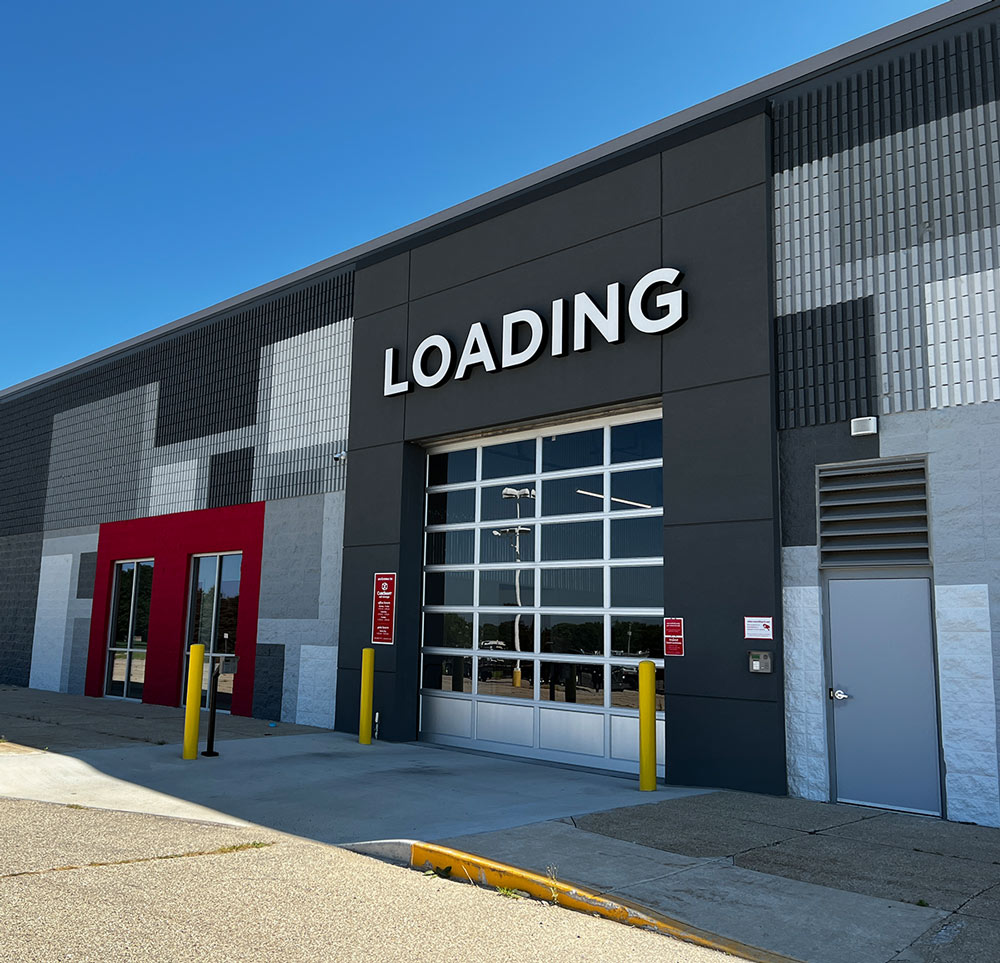 a facility garage entrance with the word loading in large white capital letters