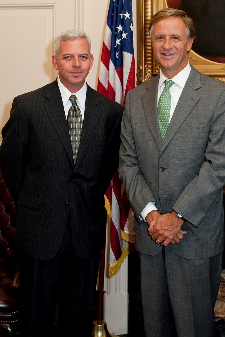 Tim Dietz smiling next to colleague while both wear suits