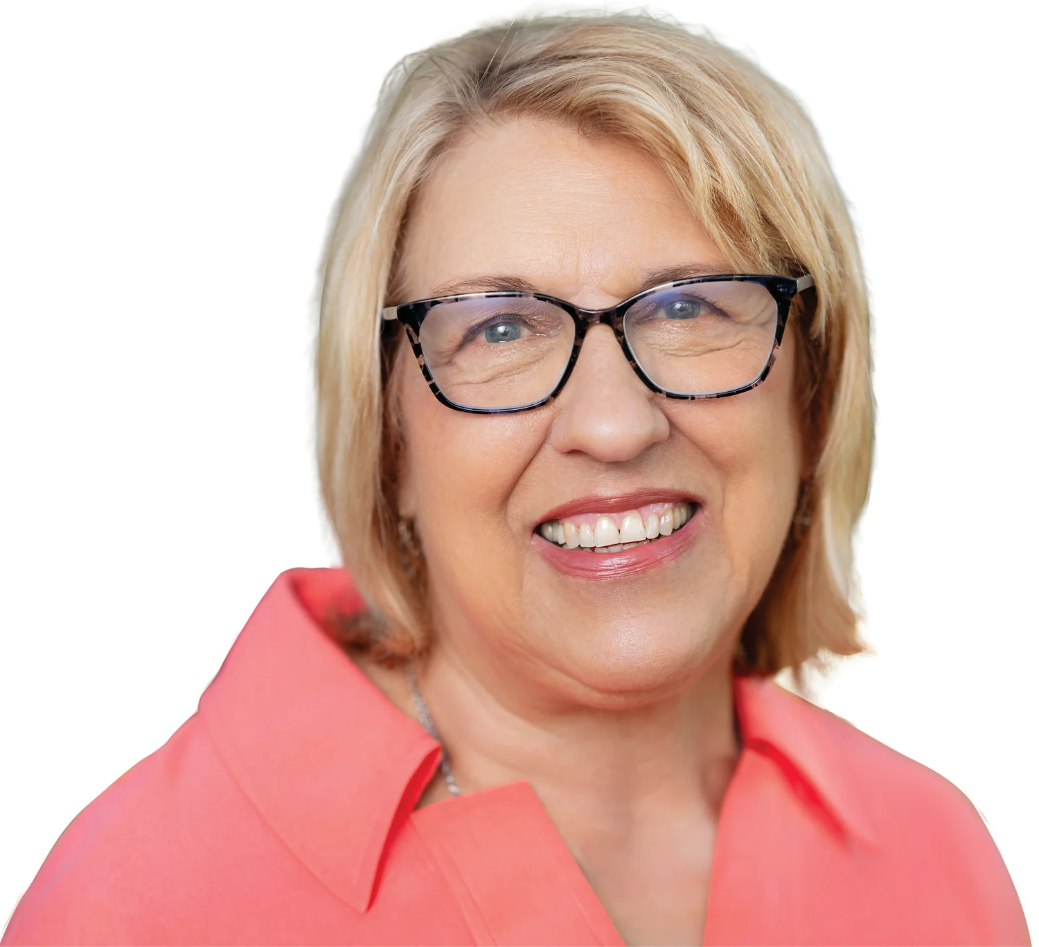 Close-up headshot of Ann Parham, smiling, wearing glasses and a pink shirt.