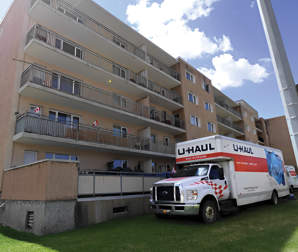 U-HAUL truck parked in front of an apartment complex.
