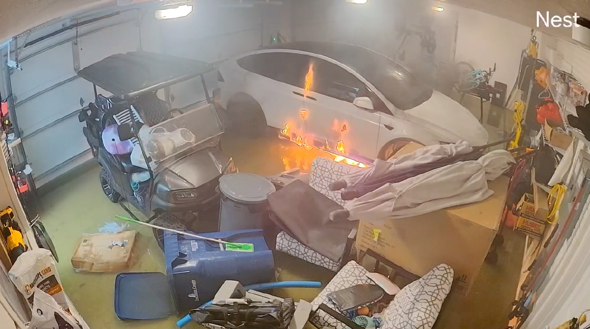 video screenshot of Telsa car in garage catching fire