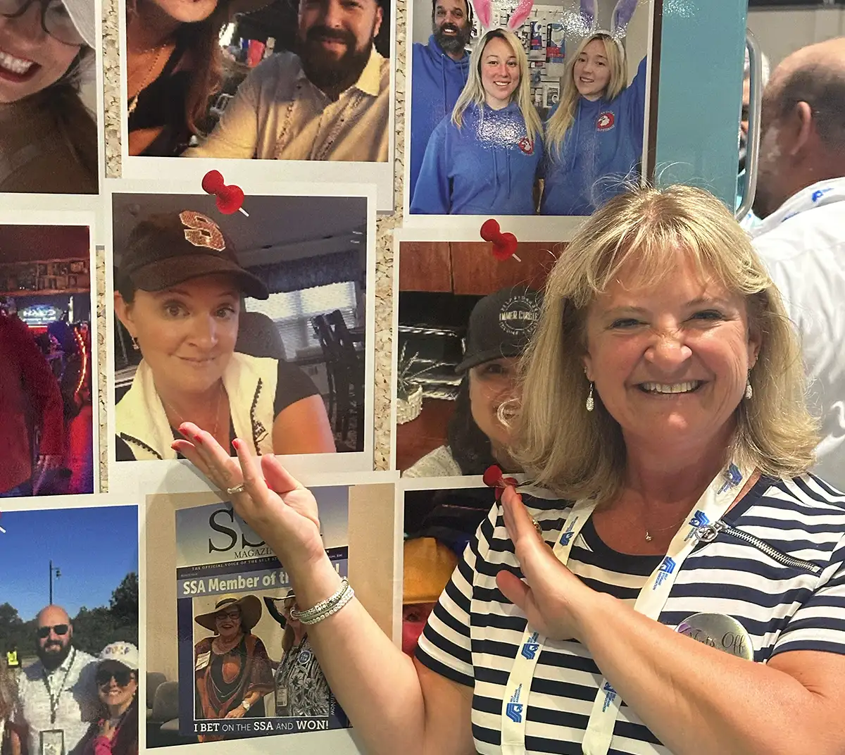 Lou Barnholdt pointing to a printed photo of a lady wearing a hat on a truck