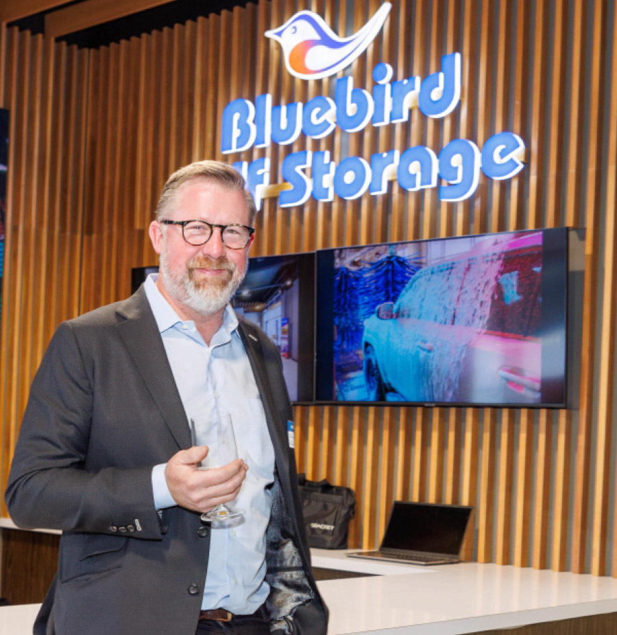 Jamie Bennett in front of reception desk inside Bluebird Self Storage lobby