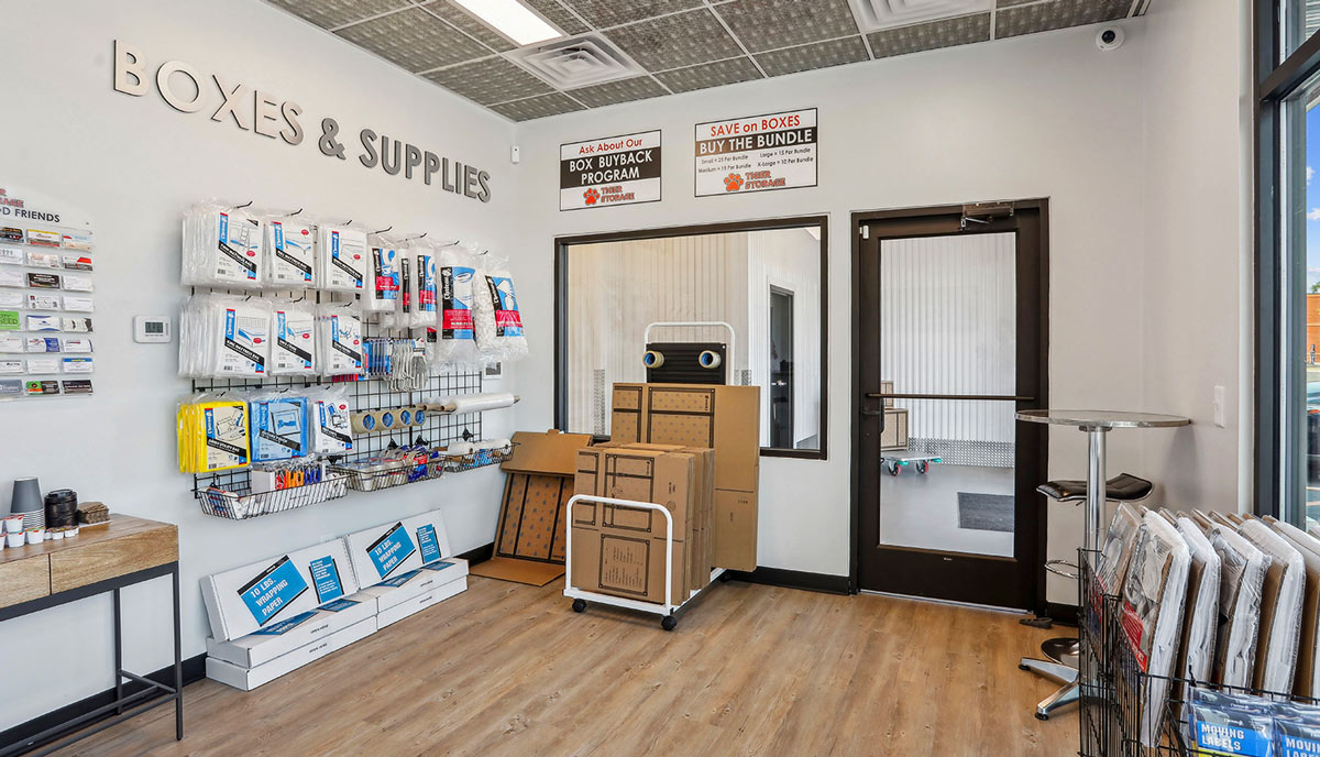 a storage facility lobby with various boxes and supplies on sale