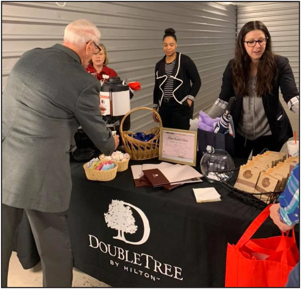 Man getting coffee from Hilton Double Tree table