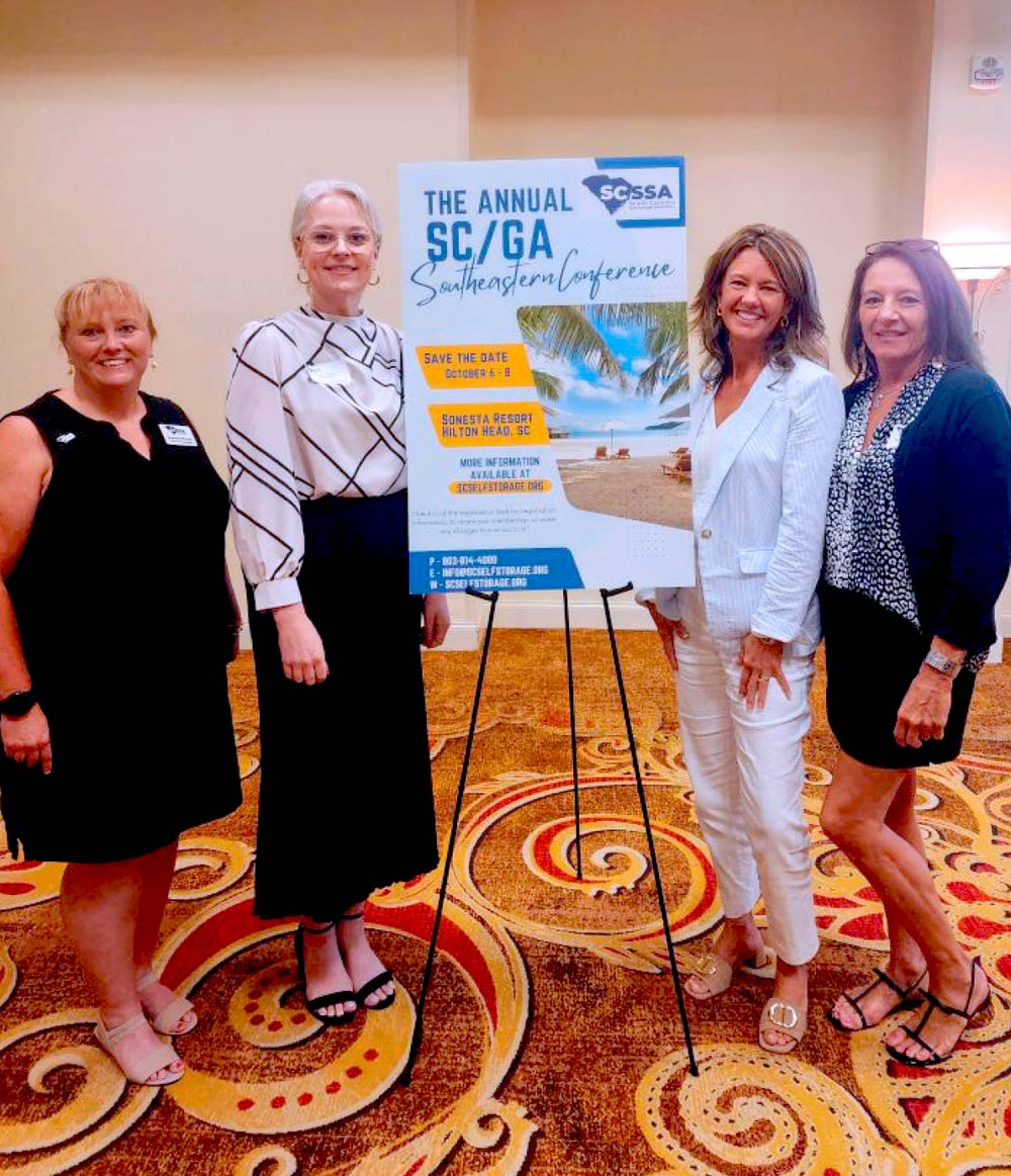 group photo of Stephanie Winfree, Jennifer Downer, Jane Sauls, and Cindy Ashby standing next to a SCSSA sign