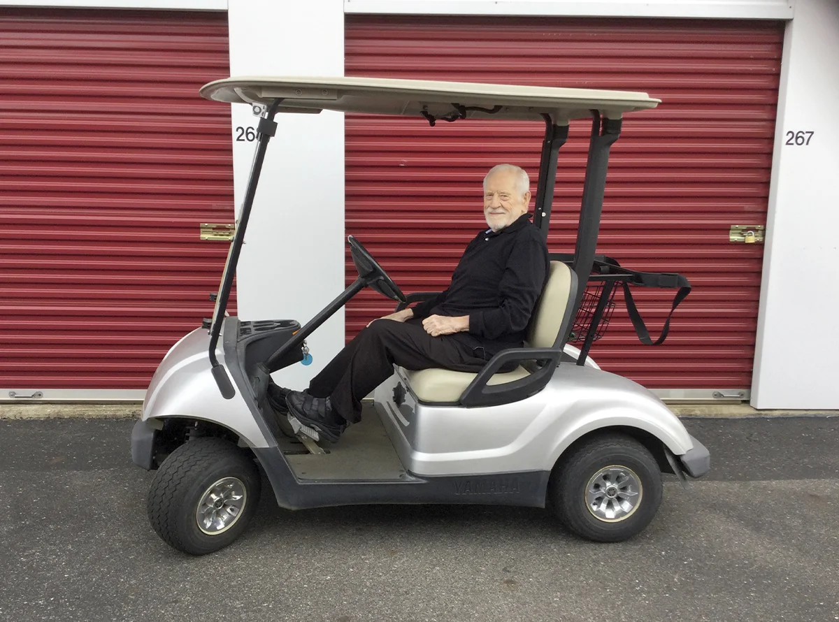 Herb Chelton on a golf cart at Brentwood Stor-N-Lok