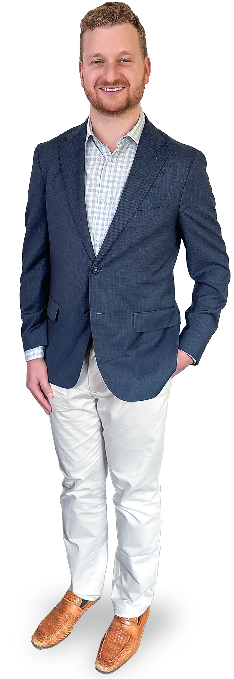Portrait orientation photograph full-body shot of Noah Starr smiling and posing with short dark brown hair and a dark brown beard wearing a dark navy blue business blazer suit, a light sky blue and white checkered pattern style button-up dress shirt underneath, white business dress pants, and woven brown dress shoes standing with his left hand resting inside the left side pocket of his white dress pants