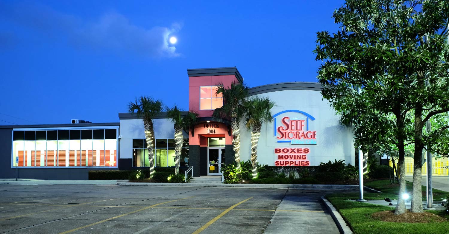 Elmwood Self Storage and Wine Cellar facility at dusk, with its office and main building lit up under a moonlit sky.