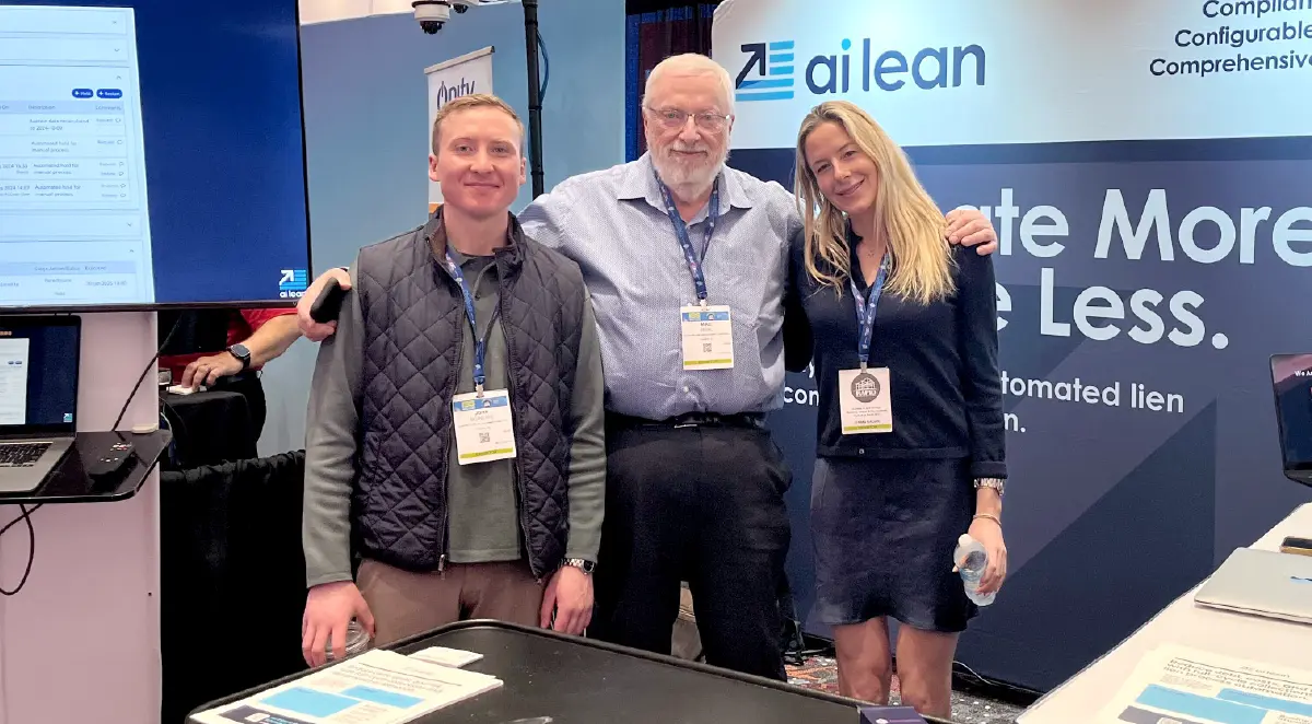 Ai Lean team members, two men and one woman, standing together at an industry event, representing their automated lien management solution.