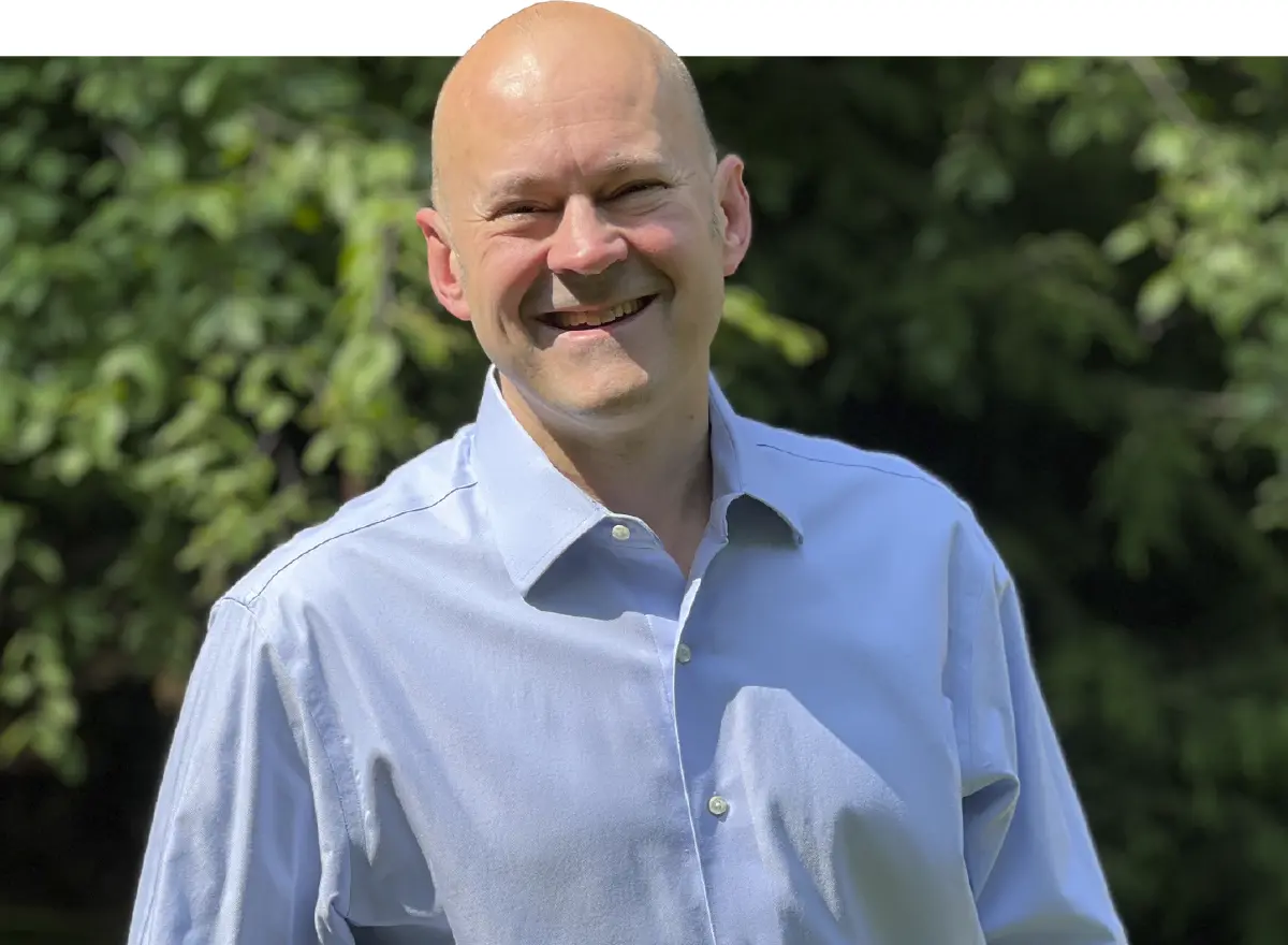 Headshot of Luke Shardlow looking friendly and approachable in a natural light setting.
