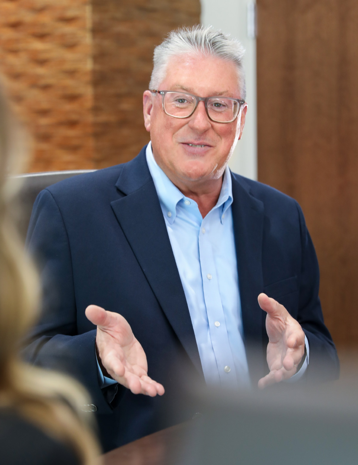 Guy Middlebrooks at conference table with hands in front mid-conversation