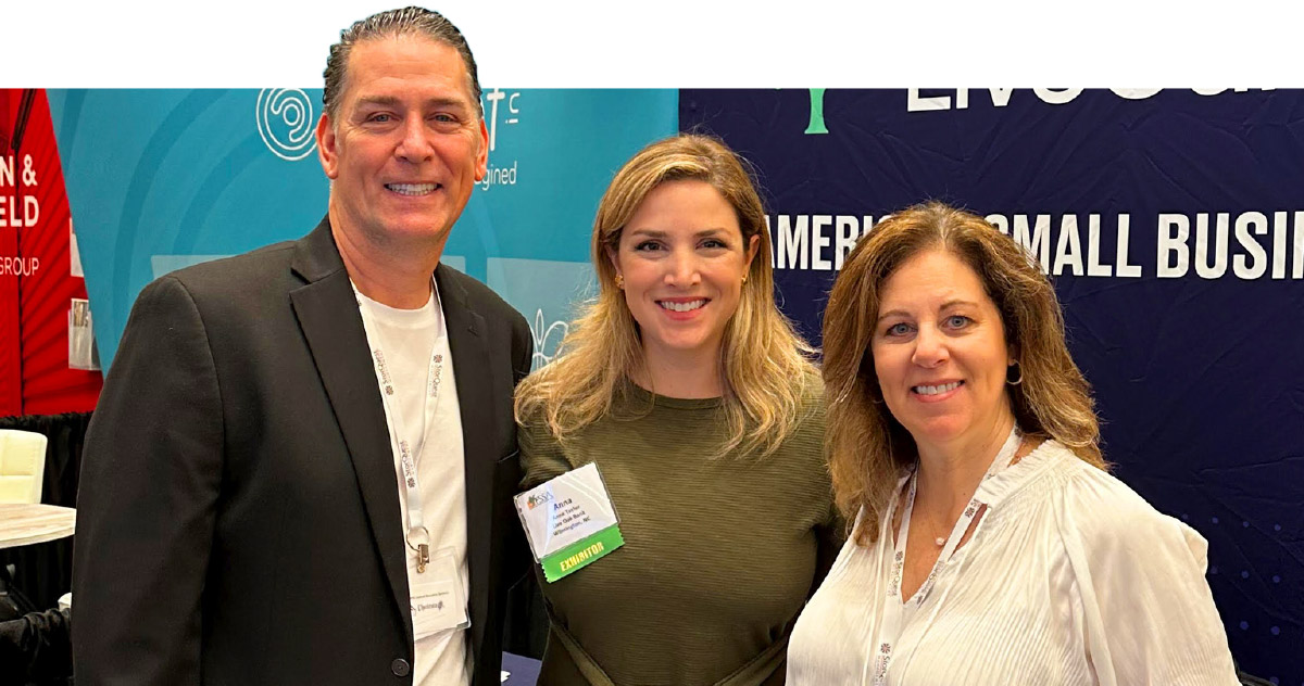 Anna Taylor with Dominic and Joanna Garrambone at Live Oak Bank's trade show booth