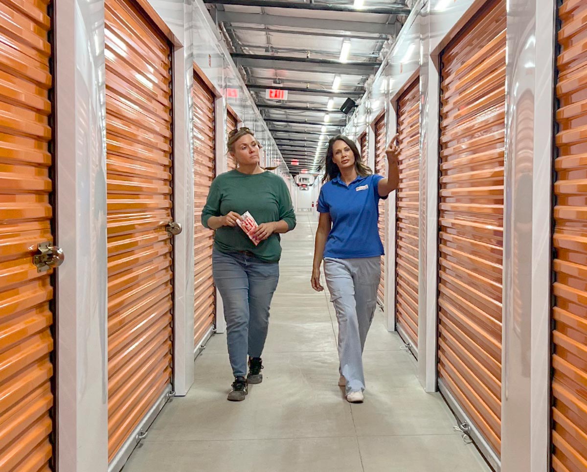 Marie Laffoon walking a customer to her unit through a hallway