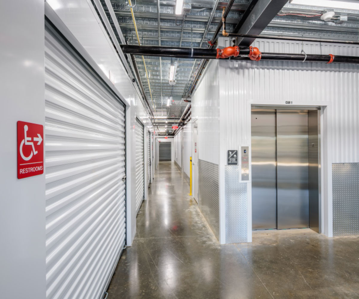 aisle of white storage unit doors
