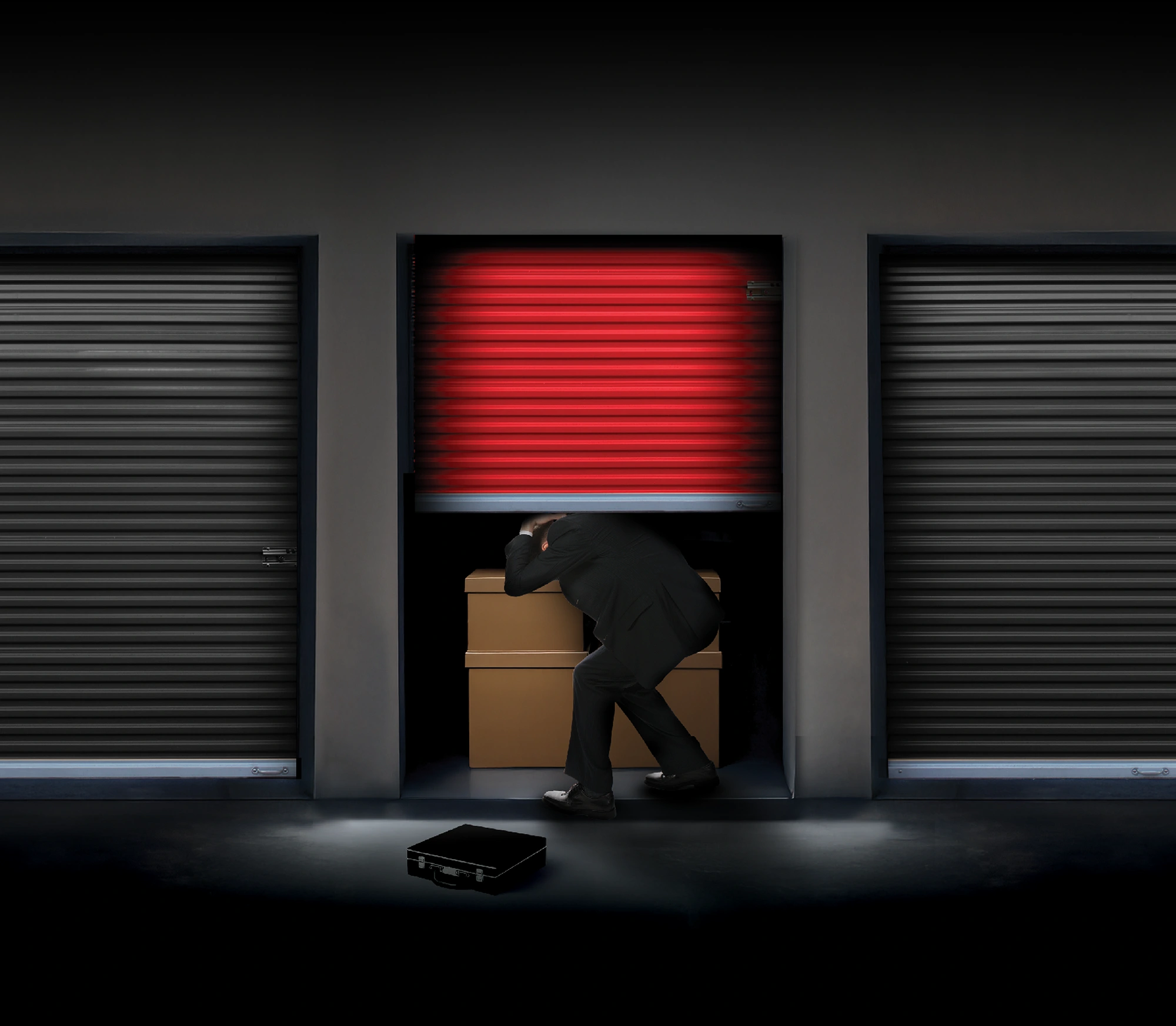 business man being crushed by a red storage unit door