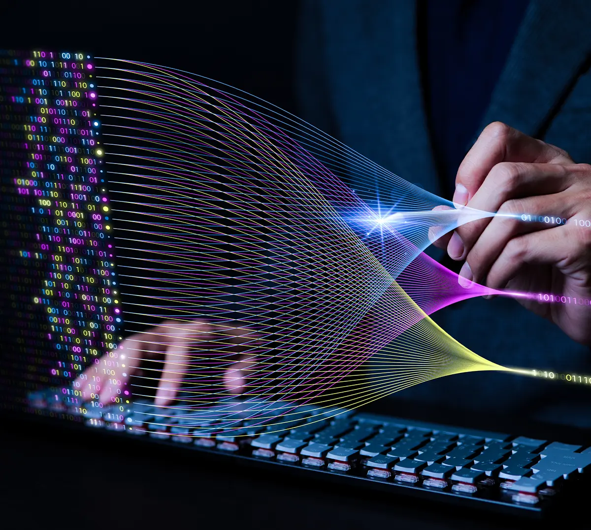 Abstract visualization of data analytics: Binary code streams into a system, which a person's hand separates into colored, organized data flows over a keyboard