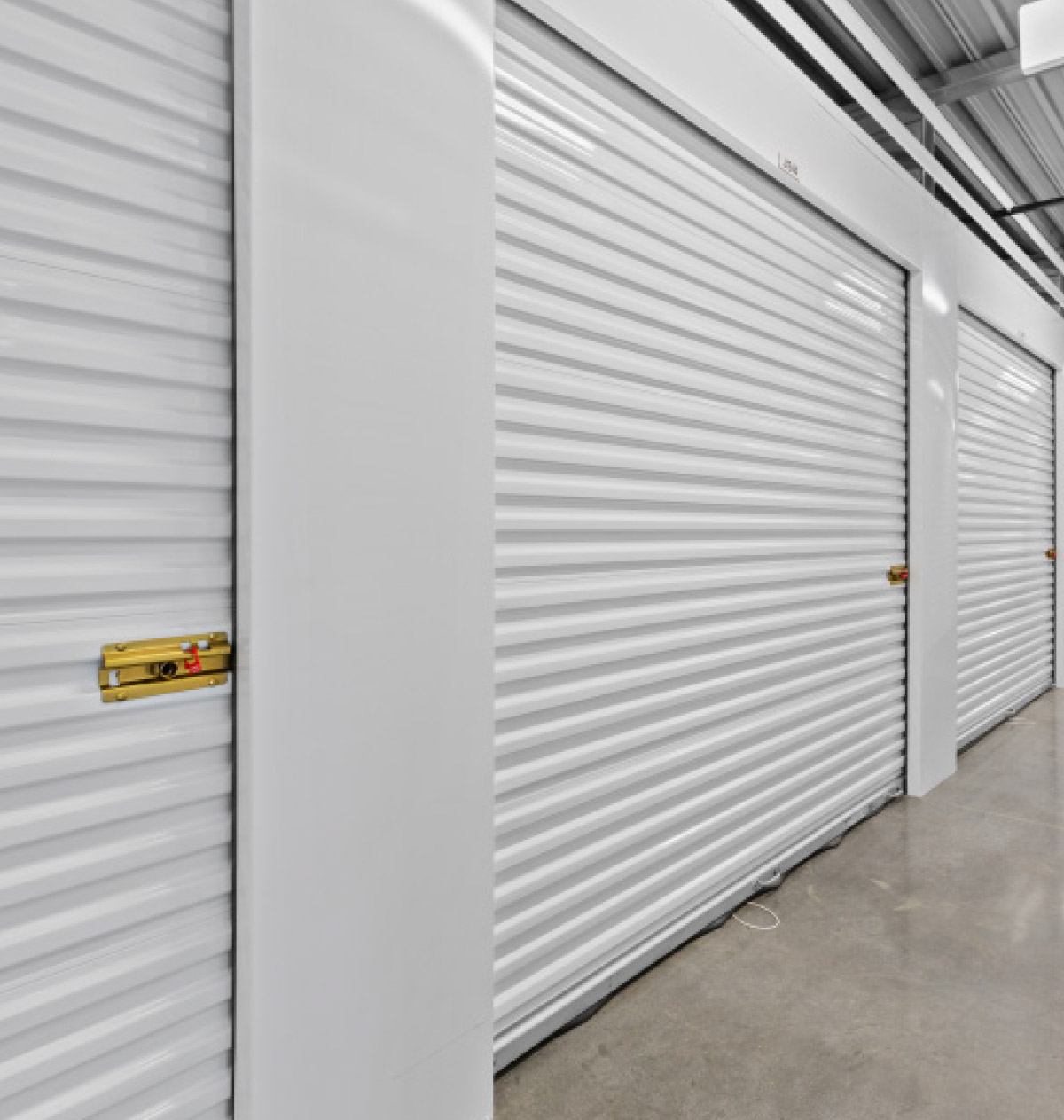 aisle of white storage unit doors