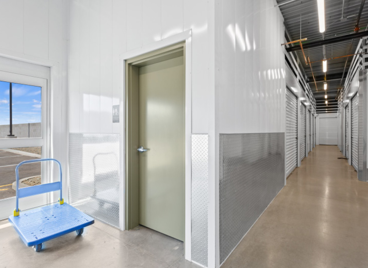 aisle of white storage unit doors