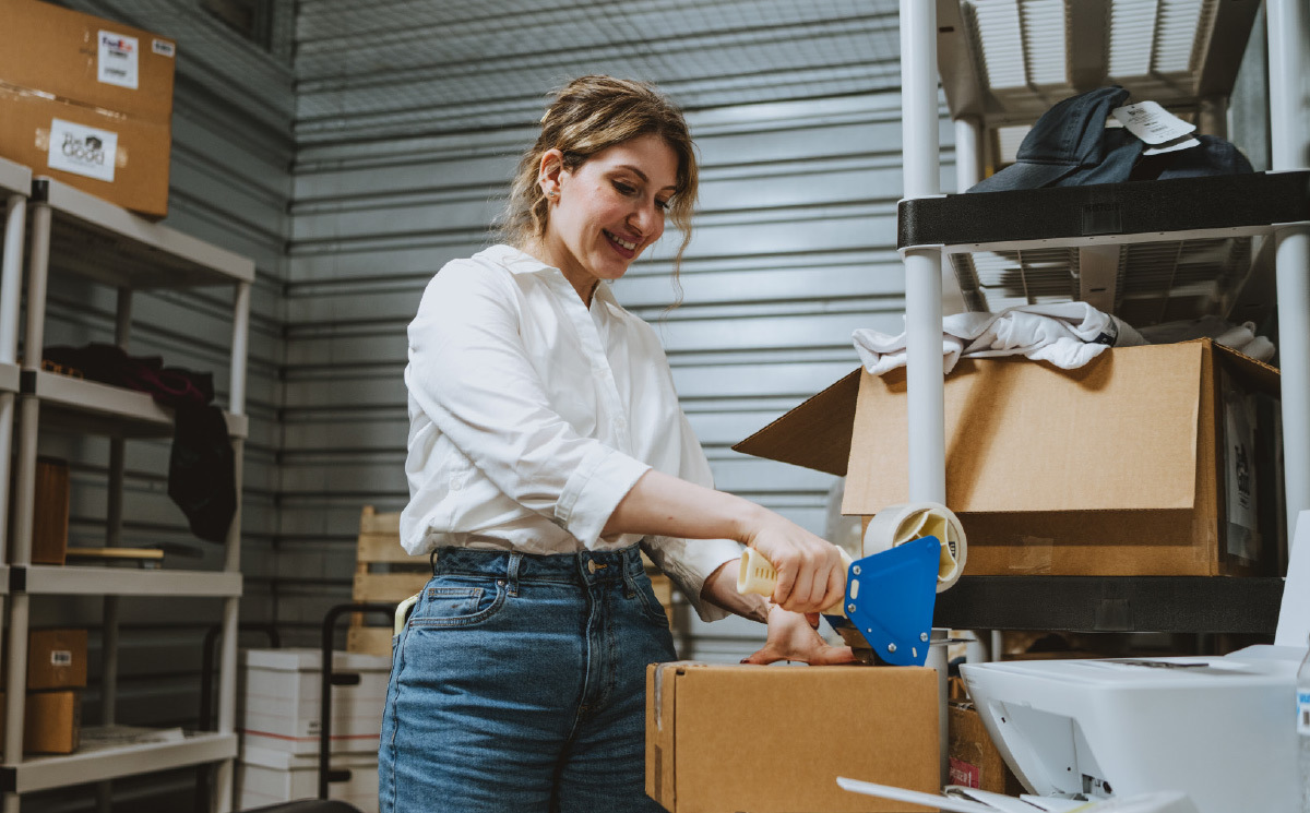 A Warehouse Anywhere customer seals a box within a unit