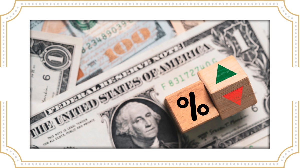 wooden blocks with a percent symbol and directional arrows sitting on top of United States one-hundred and one-dollar bills
