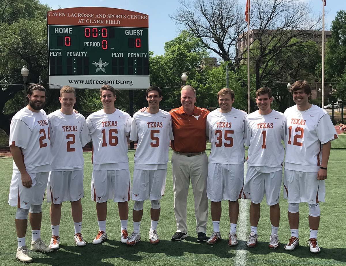 Noah Starr on field posing for a group photo with his lacrosse team 