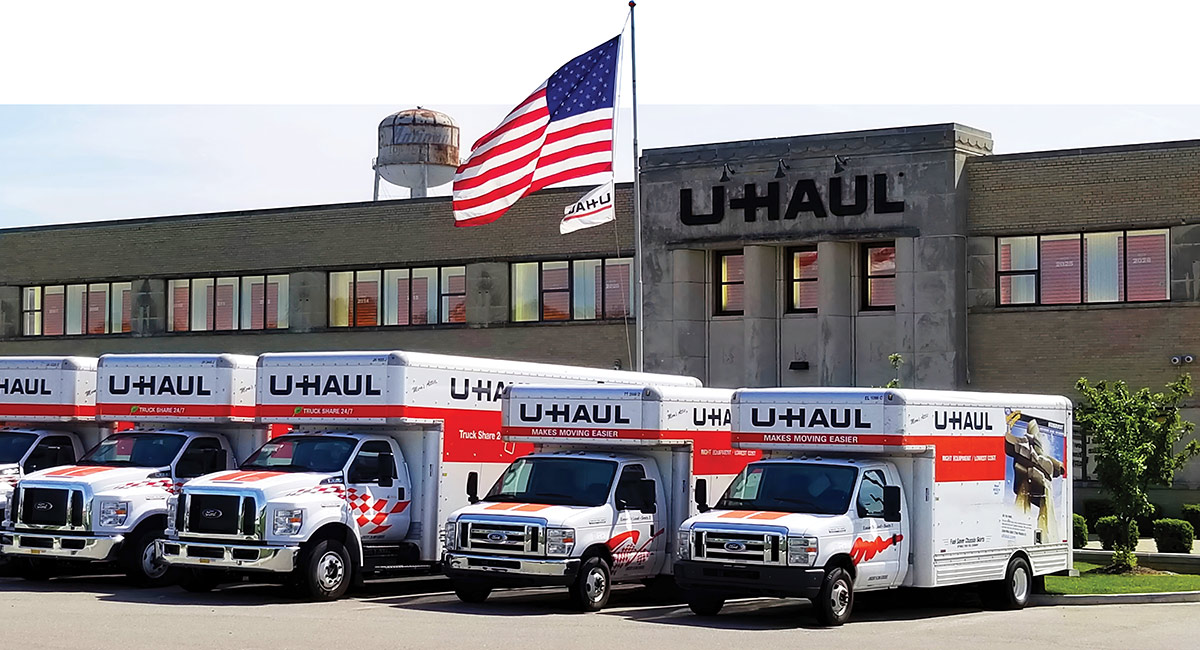 U-Haul trucks outside a U-Haul Storage Center with American Flag flying above