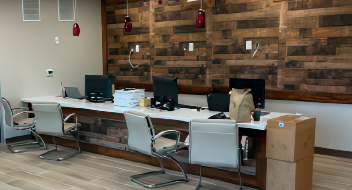 Modern office reception area with a long white desk and a rustic reclaimed wood feature wall.