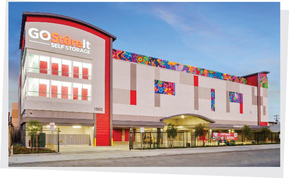 The large exterior of a modern Go Store It Self Storage building accented with bright, colorful geometric murals.