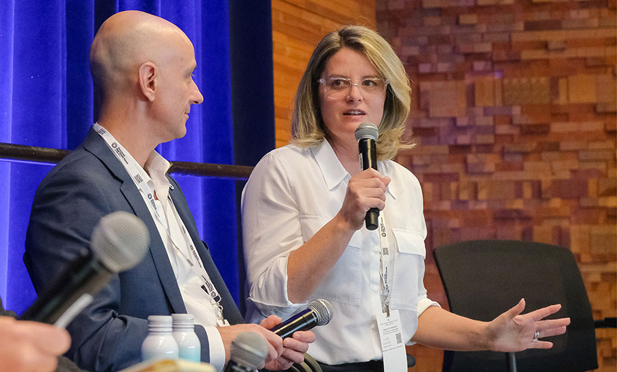 SmartStop’s Executive Vice President Bliss Edwards speaks into a microphone during a panel discussion