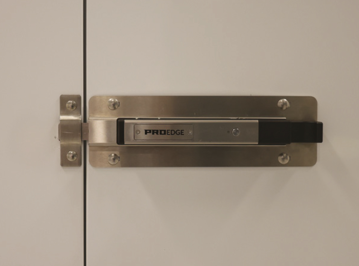 A close-up shot of a ProEdge electronic smart lock mechanism securely bolted onto a clean, white flush-mount storage door.