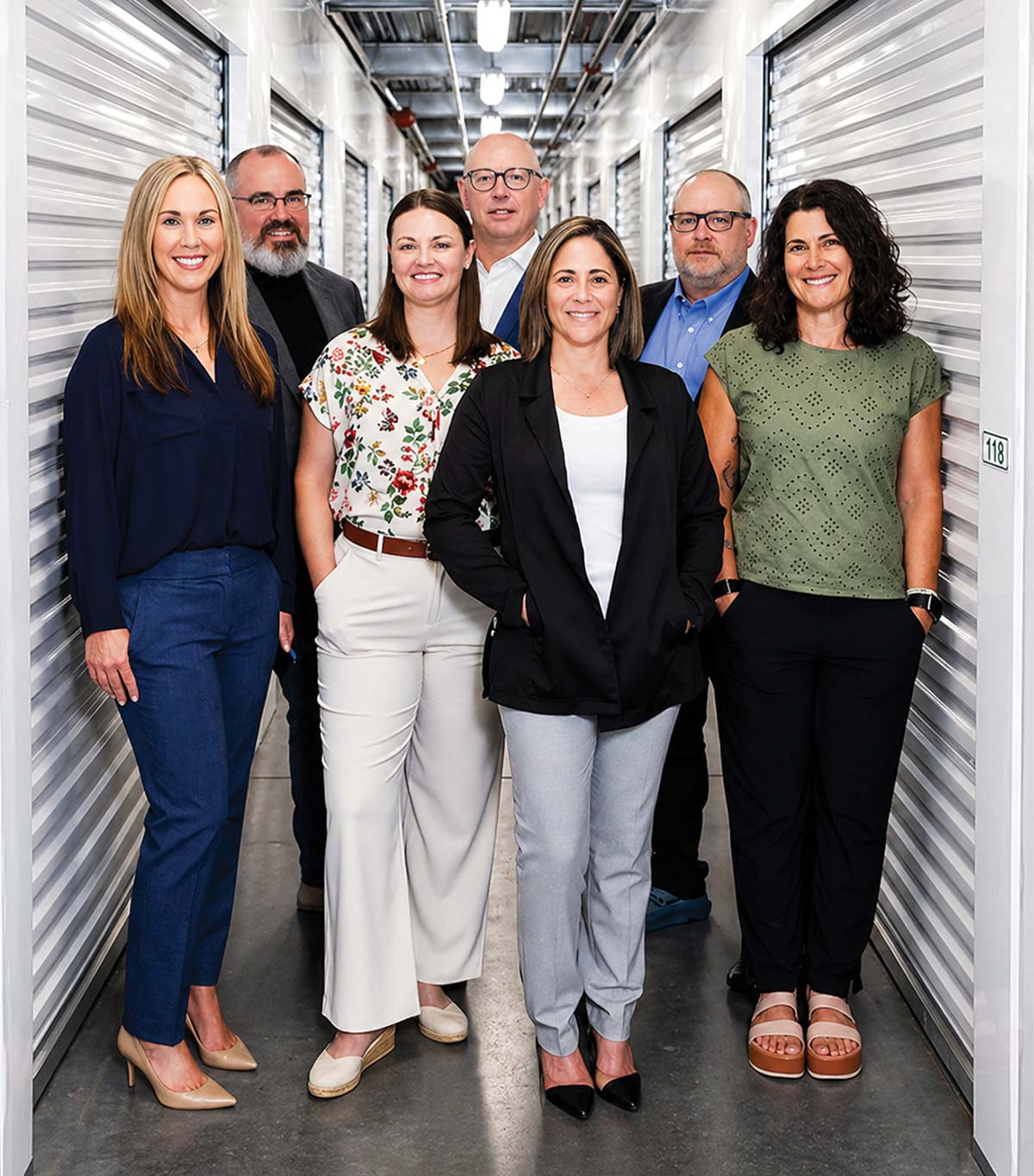 Thaddeus Campbell and several of the S3 Partners team individuals smiling inside a self-storage facility