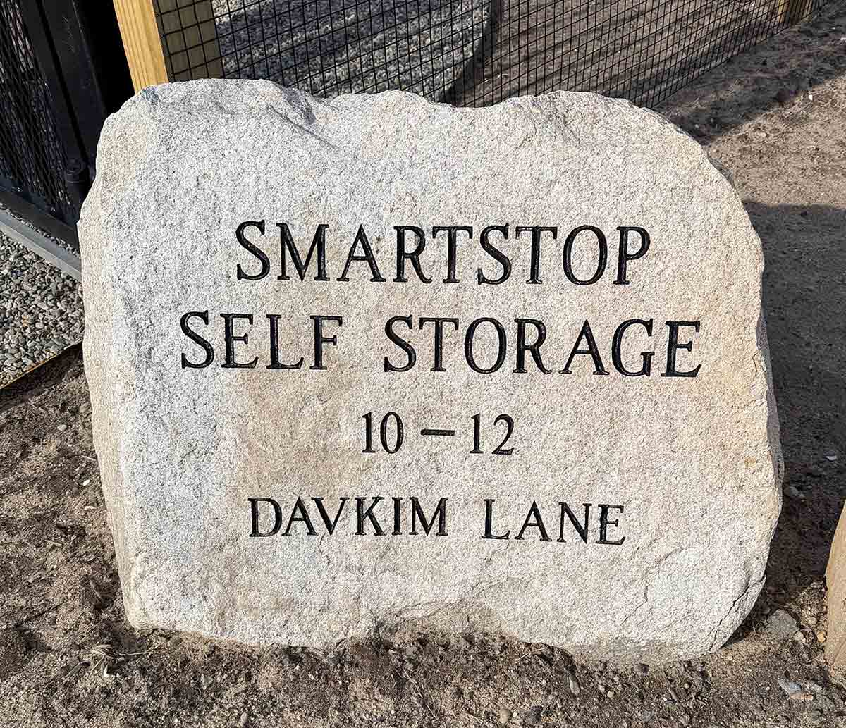 A large stone sign reading SmartStop Self Storage on Davkim Lane.